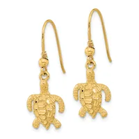 Pair of gold sea turtle dangle earrings with textured shells, attached to curved ear wires with small round beads.