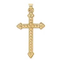 A gold cross pendant with ornate floral filigree detailing on the arms and shaft, displayed against a white background.