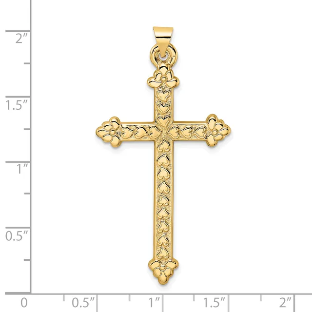 A gold cross pendant with ornate floral detailing on the arms and shaft, displayed against a ruler showing it measures approximately 1.75 inches tall.