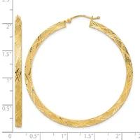 Gold twisted hoop earrings with textured finish, displayed next to a ruler showing approximately two inches in diameter.