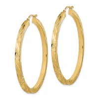 Pair of gold hoop earrings with a textured diamond-cut surface and polished inner edges, shown against a white background.