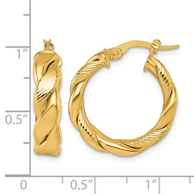 A pair of twisted gold hoop earrings with textured surfaces, displayed next to a ruler showing they measure approximately one inch in diameter.