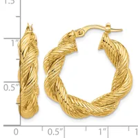 Pair of twisted gold hoop earrings with post and clutch backs, displayed next to a measurement ruler showing approximately one inch in diameter.