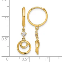 Gold hoop earrings with diamond studs and dangling open circle charms, shown against a measurement scale.
