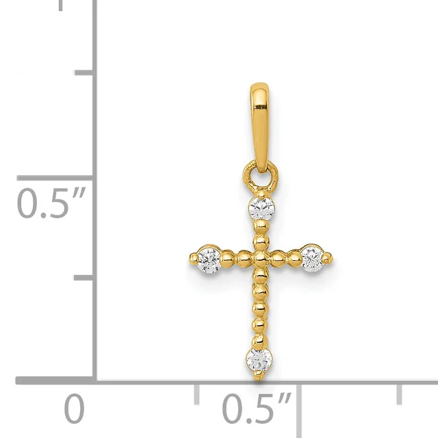 Gold cross pendant with cubic zirconia stones at each cardinal point and center top, shown with a measurement scale indicating approximately half an inch in height.