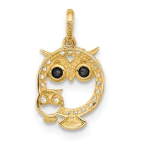 Gold owl pendant with black stone eyes and white crystal accents around the body and wings, suspended from a gold bail.
