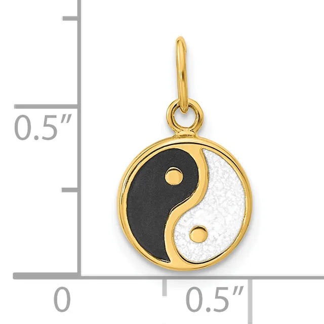 Gold-toned yin-yang pendant with black and white enamel halves and small gold dots, shown next to a ruler indicating approximately 0.5 inches in width.
