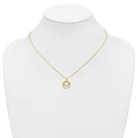 Gold-toned necklace with a delicate chain and a pendant featuring two nested circular rings, displayed on a white mannequin bust.