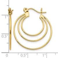 A pair of polished gold triple concentric hoop earrings with posts and backs, displayed next to a measurement scale showing approximately one inch in length.
