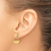 A gold circular drop earring with a polished finish hanging from a post and ball stud, worn on a pierced earlobe.