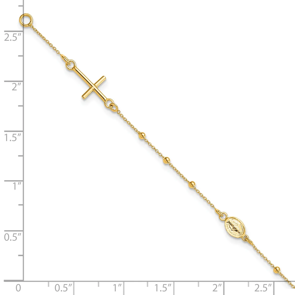 A gold-toned chain bracelet with a sideways cross pendant and a small oval medallion charm, displayed against a ruler showing it measures approximately 2.5 inches in length.