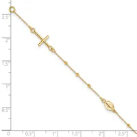 A gold-toned chain bracelet with a sideways cross pendant and a small oval medallion charm, displayed against a ruler showing it measures approximately 2.5 inches in length.