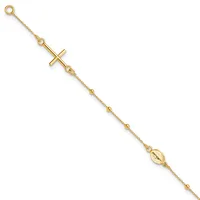 Gold-toned bracelet with a cross pendant and oval religious medal charm, connected by a delicate chain with small spherical beads.