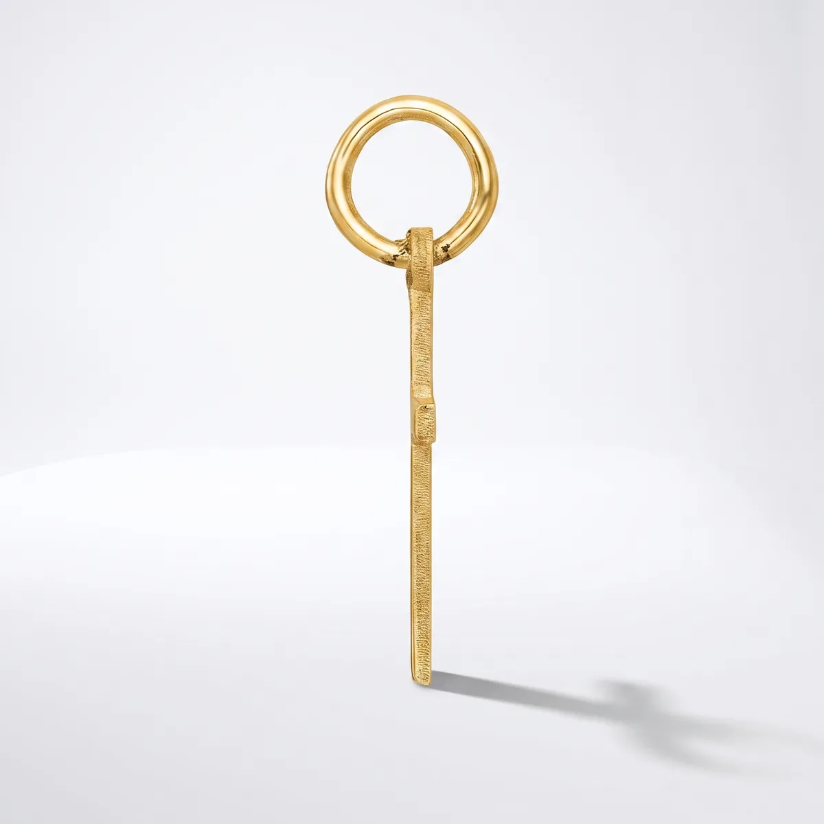 A gold-toned metal key with a circular loop handle at the top and a long rectangular shaft, shown against a white background.