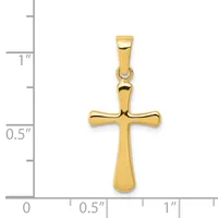 A polished gold cross pendant with rounded ends and a small loop at the top, shown next to a ruler indicating it measures approximately one inch in height.