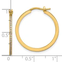 Gold hoop earrings with diamond accents along the front, shown with a measurement scale indicating approximately one inch in diameter.