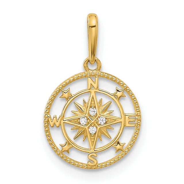Gold compass rose pendant with cardinal directions marked N, S, E, W, surrounded by a circular rope-textured border and small stars, featuring white stone accents in the center.