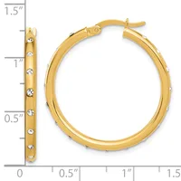 Gold-tone hoop earrings with crystal accents displayed next to a ruler showing approximately 1.5 inches in length.