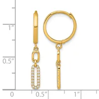Gold hoop earrings with one featuring a dangling oval pendant set with cubic zirconia stones, displayed next to a measurement ruler.