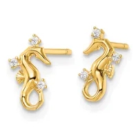 A pair of gold seahorse-shaped stud earrings with round diamond accents positioned along the body and tail of each seahorse.