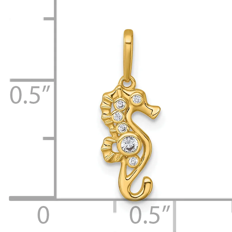 Gold seahorse pendant with cubic zirconia stones arranged along its body, shown next to a measurement scale indicating approximately half an inch in height.