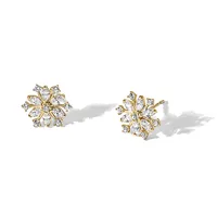 A pair of gold stud earrings with marquise-cut and round diamonds arranged in a floral cluster design, displayed on a white surface with shadows.