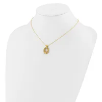 Gold-toned leaf-shaped pendant necklace displayed on a white mannequin bust.