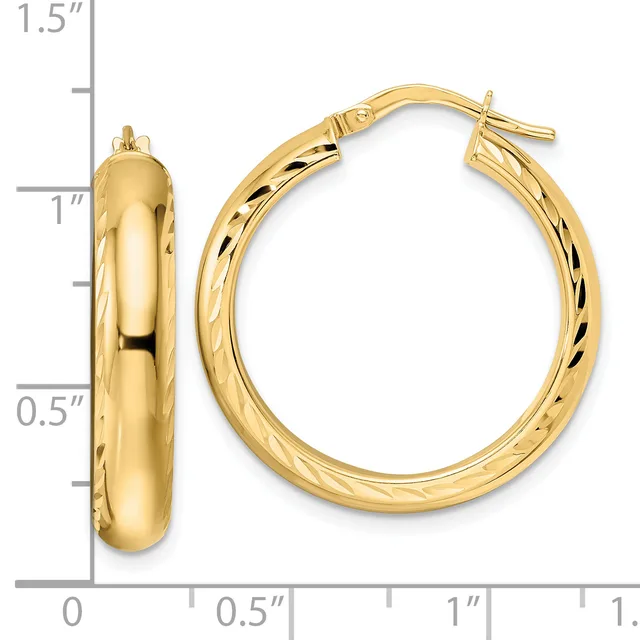 Pair of polished gold hoop earrings with textured inner surfaces, shown next to a ruler measuring approximately one inch in diameter.