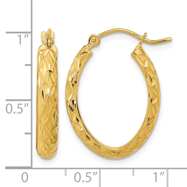 Pair of gold hoop earrings with textured diamond-cut surface, displayed against a ruler showing approximately one inch in length.
