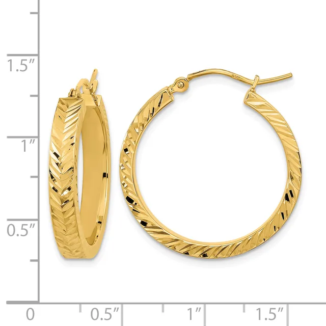 Pair of gold hoop earrings with textured surface and hook closures, displayed next to a measurement ruler showing approximately one inch diameter.