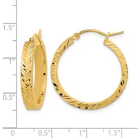 Pair of gold hoop earrings with textured surface and hook closures, displayed next to a measurement ruler showing approximately one inch diameter.