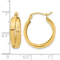 Pair of gold hoop earrings with polished and textured surfaces, shown next to a measurement scale indicating approximately one inch in diameter.