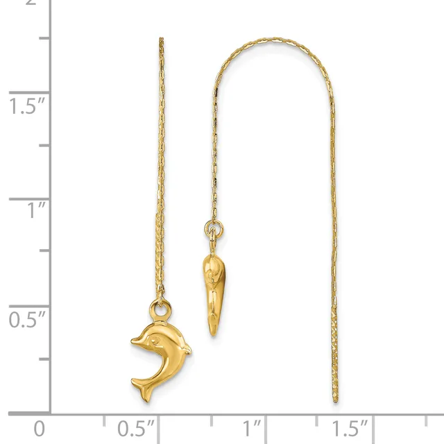 Two gold threader earrings displayed against a measurement scale: one featuring a dolphin charm and one with an elongated cone-shaped pendant.