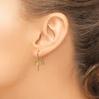 A woman wearing gold dragonfly drop earrings on hook wires, shown from the side view of her ear and neck.