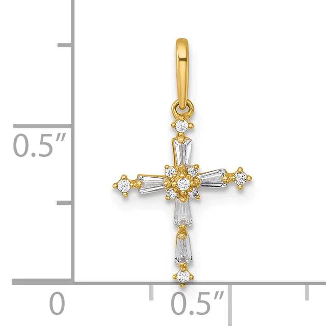 A gold cross pendant with round and baguette-cut cubic zirconia stones arranged in a cluster pattern, shown against a ruler measuring approximately 0.5 inches wide.