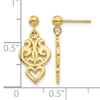 Gold-colored dangle earrings with ornate scrollwork and a heart design, shown next to a ruler indicating approximately one inch in length.