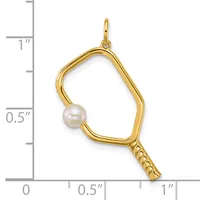 Gold-toned pendant charm featuring an irregular quadrilateral frame with a white pearl accent and textured handle section, shown against a measurement scale.