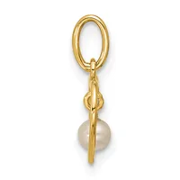 Gold oval keyring with a decorative knot detail and a round cream-colored pearl hanging from the bottom.