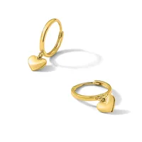 Two gold-toned hinged bangle bracelets, each with a small heart charm attached, displayed from different angles against a white background.