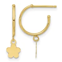 A pair of gold hoop earrings, one with a flower charm attached, displayed against a white background.