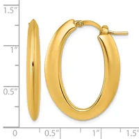 A pair of polished gold-colored oval hoop earrings with posts and backs, shown against a measurement scale indicating approximately one inch in height and half an inch in width.