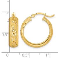 Pair of gold hoop earrings with textured surface and diamond-cut pattern, shown next to a ruler measuring approximately one inch in length.