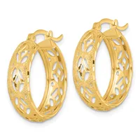 A pair of gold hoop earrings with textured and pierced leaf-like patterns on the outer surface, shown against a white background.