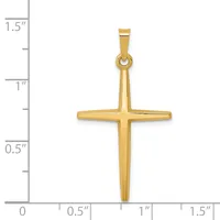 A polished gold cross pendant shown next to a ruler indicating the pendant is approximately one inch wide and one and one-half inches tall including the bail.