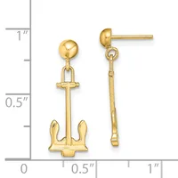 Gold-colored dangle earrings featuring anchor charms suspended from ball studs, displayed against a measurement scale showing approximately one inch in length.