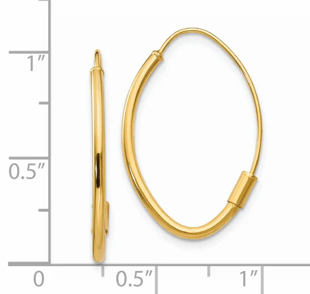 A pair of polished gold oval hoop earrings displayed next to a ruler showing measurements up to one inch.