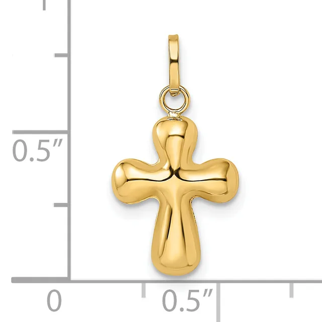 A polished gold cross pendant with rounded lobes at each end, shown next to a ruler indicating approximately half an inch in height.
