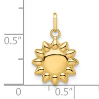 Gold sun-shaped charm with a smooth round center surrounded by pointed rays, shown next to a ruler indicating approximately half an inch in size.