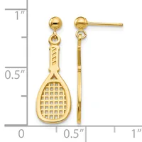 Pair of gold-colored tennis racket dangle earrings with ball studs, shown next to a ruler measuring approximately one inch in length.