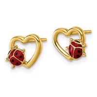 A pair of gold heart-shaped stud earrings, each with a red enamel ladybug charm suspended from the bottom.